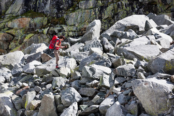 Young woman is hiking in highlands of Altai mountains, Russia