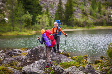 Young people are hiking in highlands of Altai mountains, Russia