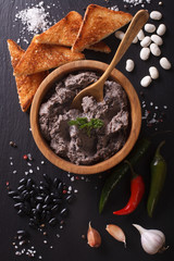 Mexican cuisine: pate of black beans close up. vertical top view
