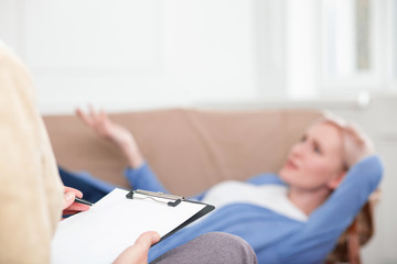 Cheerful girl is sharing her feelings with therapist