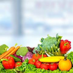 Vegetables and fruits over green background.