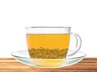 Transparent cup of green tea on wooden table isolated on white