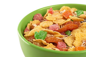 Bowl of muesli and dried fruit isolated on a white background.