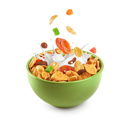 Bowl of muesli and dried fruit isolated on a white background.