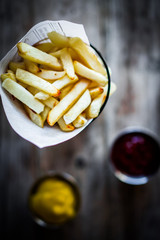French fries on rustic wooden background