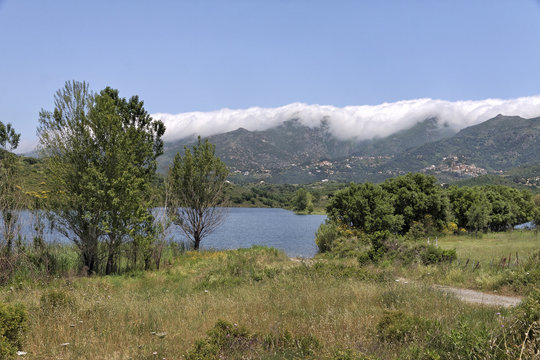 Lac de Padula (Padula lake), in the background the mountain village Oletta in the Nebbio region, Northern Corsica, France, Europe