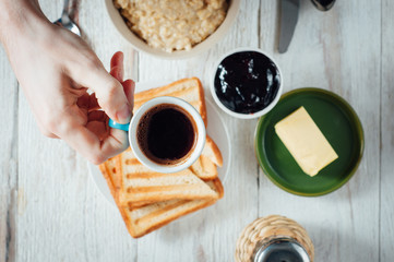 Man hands eating toast for breakfast
