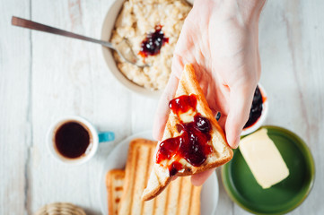 Man hands eating toast for breakfast