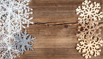 Christmas background. Snowflakes border on grunge wooden board.