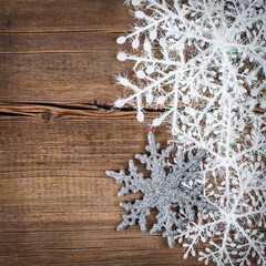 Christmas background. Snowflakes border on grunge wooden board.