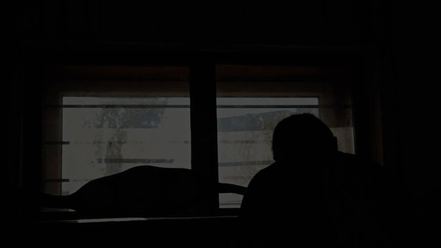 Guy stalled at the window silhouette