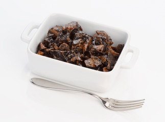 porcelain pan with squid cooked in its ink