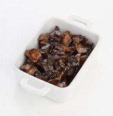 porcelain pan with squid cooked in its ink