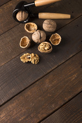Fototapeta na wymiar walnuts with nutcracker on a rustic table