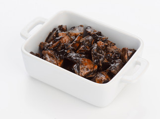porcelain pan with squid cooked in its ink