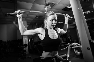 Fototapeta na wymiar Young muscular woman doing workout