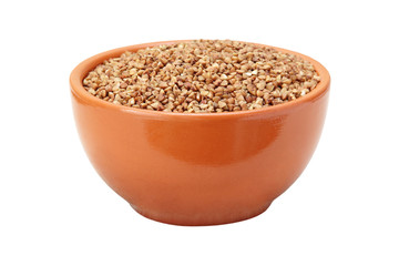 Buckwheat in brown ceramic bowl isolated on white.