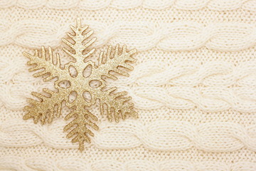 winter background snowflake on knitted fabric