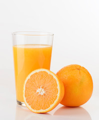 glass of orange juice and orange pieces