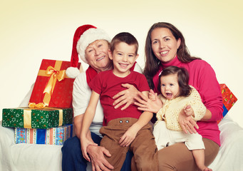 happy family with box gift, woman with child and elderly - holiday concept