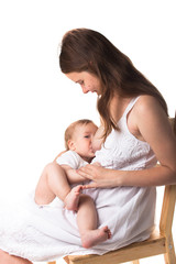 Mom feeds the baby breast, light background