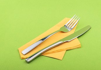 Fork and knife on green background