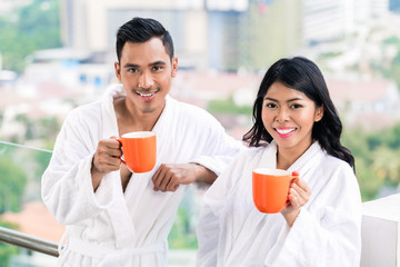 Asian couple in morning front of city skyline