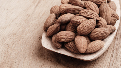 Almonds on wooden spoon