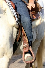Cowboy foot in the stirrup of the horse during the ride