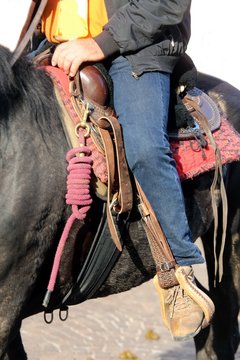 Cowboy foot in the stirrup of the horse