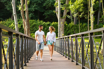 Guy and a girl walk in the park.