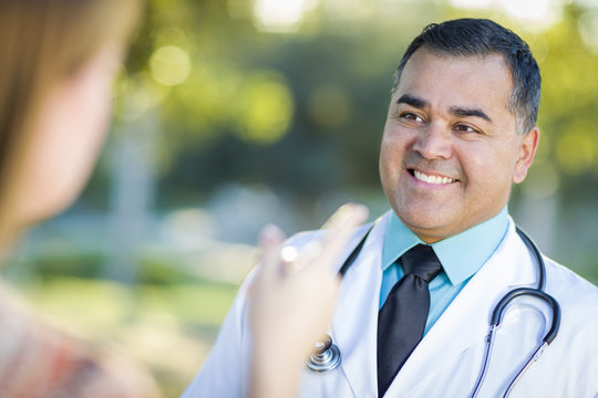 Hispanic Male Doctor Or Nurse Talking With A Patient