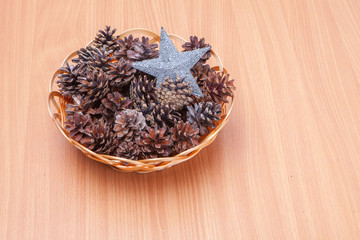 Stack of evergreen pinecones and silver start