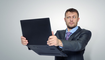 Bearded businessman holding a laptop