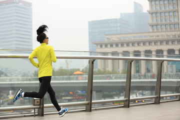 Fototapeta na wymiar young fitness woman runner running on city