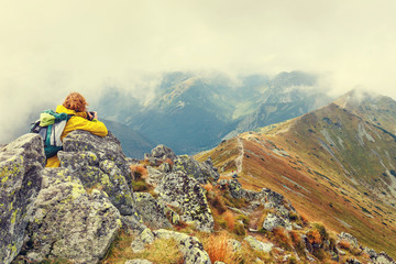 Female photographer shooting a mountain scenery