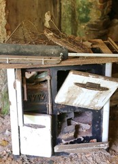 rusty wood-burning stove in an old abandoned destroyed house