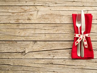 Cutlery kitchenware on old wooden boards background