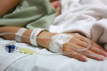 Fototapeta premium Saline solution on patients woman hand.