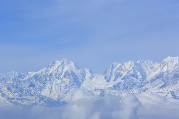 Fototapeta na wymiar beautiful rolling clouds and snow mountain landscape