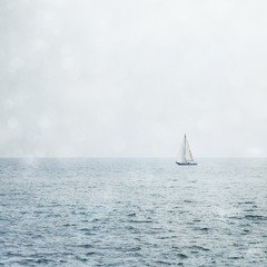 Sailboat on Misty Blue Ocean