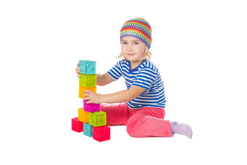 Little girl playing cubes sitting .