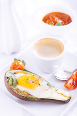 Avocado baked with egg and coffee