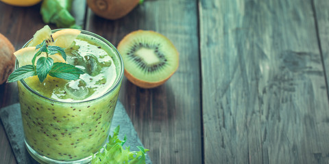 Kiwi and lemon smoothie from left side of wooden table