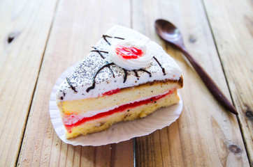 Piece of Vanilla Cake on wood table style vintage
