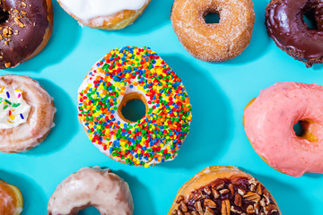 Assorted donuts on pastel blue background