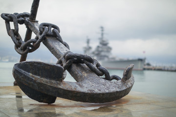 Anchor on the embankment and the cruiser in the port of Novoross - obrazy, fototapety, plakaty