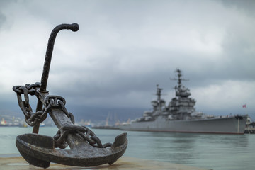 Anchor on the embankment and the cruiser in the port of Novoross