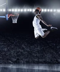Fotobehang Basketbalspeler die een atletische, geweldige slam dunk scoort in een professionele basketbalwedstrijd © Brocreative