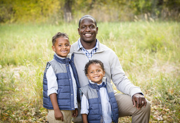 Naklejka na ściany i meble Outdoor Portrait of a Racially Diverse Father with his two sons